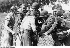 a group of people standing next to each other near a fence