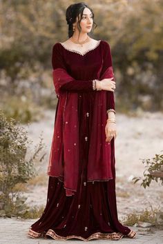 Specifically designed to add a contemporary appeal to your ethnic look, this dark maroon velvet anarkali suit surely deserves a special place in your wardrobe.This sweetheart neckline and full sleeve party wear dress highlighted with stone and zari work.Accompanied by a matching lycra churidar in maroon color with maroon net dupatta.Churidar is plain.Dupatta elaborated using stone work.This anarkali suit can be customised up to maximum size available in inches 68. Slight color variation may occur due to photographic reasons. Maroon Frock, Velvet Anarkali Suits, Maroon Anarkali, Velvet Anarkali, Girly Swag, Dress Book, Suit Salwar, Party Wear Dress, Dark Maroon