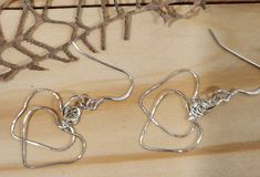 Double Heart Earrings: Sterling Silver  * Extremely light Weight * Each heart on drop ~0.75" by 0.75"  * Drop from ear wire is 1.25" * Each pair varies slightly * EAR WIRES: Sterling Silver .925:  * Ear Wires: Hypoallergenic, nickel-free, clear protective coating to prevent tarnishing * 22-gauge sterling silver: Shaped and dapped for strength * Coat of Renaissance Wax on hearts for shine and tarnish prevention. Share the Heart Tempo with a significant person in your life! Each pair is custom mad Sterling Silver Earrings With Ear Wire For Mother's Day, Heart Pendant Earrings With Ear Wire As Gift, Heart Shaped Earrings With Ear Wire For Gifts, Heart Pendant Earrings With Ear Wire For Gift, Adjustable Silver Heart Earrings For Gift, Silver Heart Pendant Earrings With Ear Wire, Mother's Day Heart Shaped Earrings With Ear Wire, Mother's Day Heart-shaped Earrings With Ear Wire, Open Heart Ear Wire Earrings As Gift