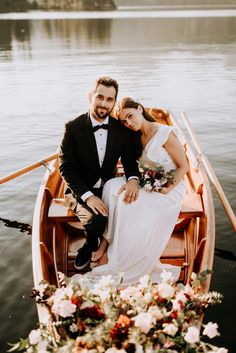 a bride and groom sitting in a row boat