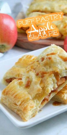 puff pastry apple slabs are stacked on a white plate with apples in the background