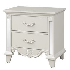 a white nightstand with two drawers on top of it and a mirror in the bottom drawer