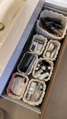 an open drawer in a bathroom filled with toiletries