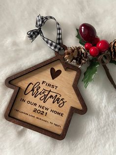 a wooden ornament that says first christmas in our new home