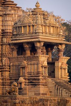 an elaborately carved structure in the middle of a forest