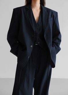 Color: Navy Pinstripe Midweight traditional suiting fabric Oversized silhouette Padded shoulders Flap front pockets Button front closure Lined 72% Polyester 22% Rayon 4% Wool 2% Spandex Dry Clean By The Frankie Shop. Imported One Size Product Measurements: 20" Shoulder 46" Bust 30" Length Model is wearing size O/S Designer Womens Suit, Navy Pinstripe Suit Women, Gender Fluid Formal Wear, Pinstripe Suit Women, Pin Stripe Blazer, Suit Aesthetic, Stripe Suit, Tailored Vest, Striped Suit