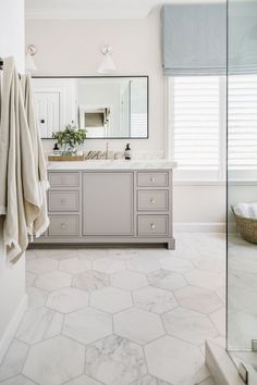 Dansing — Delphinium Design Large Hexagon Bathroom Floor, Large Hexagon Tile Bathroom, Light Gray Vanity, Hexagon Floor Tile, Primary Bathroom Design, Large Rectangle Mirror, Hexagon Tile Bathroom, Hexagon Floor, Master Bath Shower