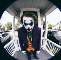 a man dressed as the joker is seen through a fisheye lens