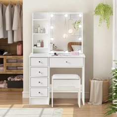 a white dressing table with lights on it