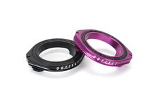 two purple and black bicycle headsets on a white background, one has an aluminum ring