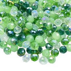 green and clear glass beads on white background