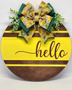 a wooden sign that says hello with sunflowers on it