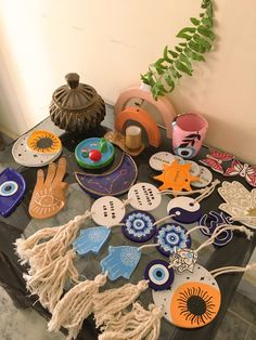 a table topped with lots of assorted items on top of a wooden table next to a potted plant