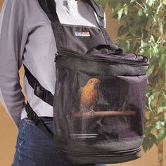 a woman wearing a backpack with a bird on it