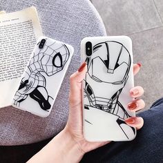 a woman holding up her phone case with iron man on it