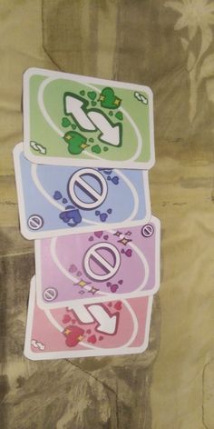 four different colored stickers on top of each other in the shape of letters and numbers