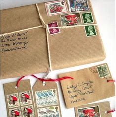 there are many stamps on the envelopes with red string attached to them, and some have writing on them