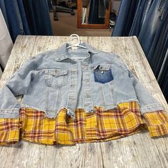 an old jean jacket is sitting on a table