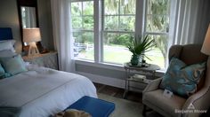 a bed sitting next to a window in a bedroom