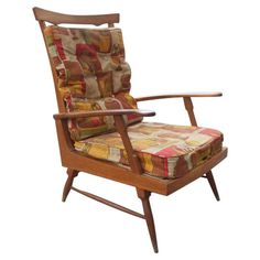 a wooden chair with colorful fabric on it's back and armrests, against a white background