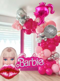 a barbie doll is surrounded by balloons and decorations