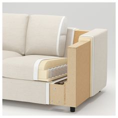 a couch with an open drawer on the back and bottom part in front of it