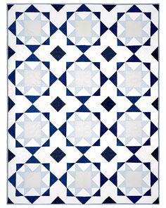 a blue and white quilt with black squares on it's sides, in the shape of stars