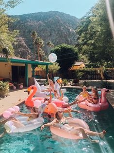 a group of people floating on top of an inflatable pool with flamingos