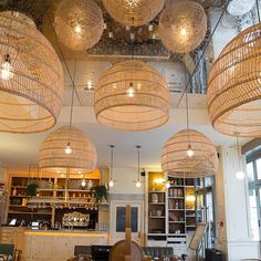 an empty restaurant with chandeliers hanging from the ceiling