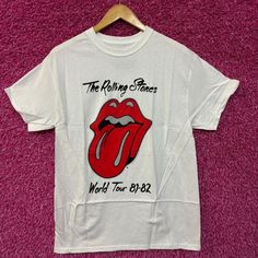 a white rolling stones t - shirt with the rolling stones world tour on it's chest