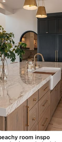 a large kitchen with marble counter tops and wooden cabinetry, along with an island in the middle