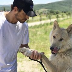 a man is petting a dog on the leash