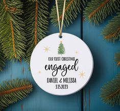 an ornament hanging from a christmas tree with the words engaged and merry written on it