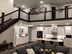 a living room filled with furniture next to a staircase