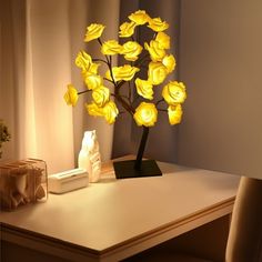 a lamp that is sitting on top of a table next to a vase with flowers