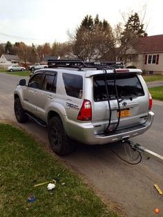 a silver suv parked on the side of a road