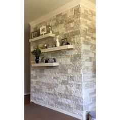 a white brick wall with shelves on it