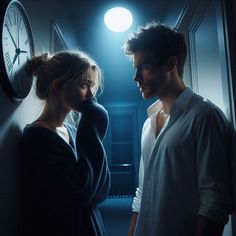 a man and woman standing next to each other in front of a clock