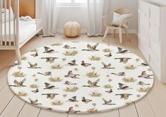 a baby's room with a white crib and wooden flooring that has ducks on it