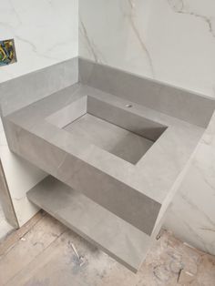 an empty bathroom with marble walls and floor