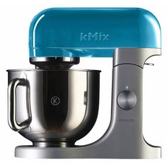 the mixer is white and silver with a cream colored top on it's stand