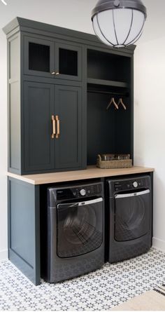 a washer and dryer in a laundry room with an open cabinet above it