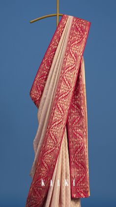 This stunning maroon Banarasi silk saree is a masterpiece of traditional elegance and refined artistry. Expertly handwoven in pure Katan silk, it showcases intricate silver zari work and captivating shikaargh motifs of flora, fauna, and scrolling vines. A celebration of Banaras's exceptional craftsmanship, this luxurious saree is a timeless heirloom, perfect for life's most special occasions.