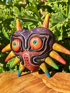 a colorful mask sitting on top of a wooden table