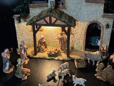 a nativity scene with figurines and lights