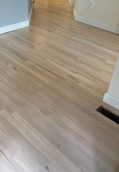 an empty living room with hard wood floors