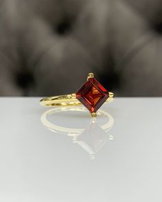 7 mm Princess / Square Red Garnet Dainty Ring, 14K Gold, Genuine Red Gemstone, 4 Prongs Modern Setting, Best Gift for Her, Handmade Ring ◎ Details ◎ ○ Gemstone Details .Natural RED GARNET Princess / Square Cut 7 mm x 7 mm approx. 1.85 ct ○ Gold Details 14K Solid Gold Weight of Ring : approx 3.00 gr Width of Band : 2.25 mm Made to Order HANDMADE ITEM ○ Upgrade to Solid 18K Gold, please click the link below: https://www.etsy.com/listing/962826004 ○ For more BIRTHSTONE Rings : https://etsy.me/2NNWR Timeless Red Ring As A Gift, Luxury Ruby Ring With Diamond Cut For Gift, Classic Red Birthstone Ring With Ethical Gemstones, Luxury Red Birthstone Ring In 14k Gold, Luxury Ruby Ring With Diamond Cut As Gift, 14k Gold Ruby Ring With Diamond Cut For Gift, Luxury Red 14k Gold Birthstone Ring, Luxury 14k Gold Red Birthstone Ring, Classic Lab-created Ruby Birthstone Ring As Gift