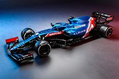 a red and blue race car on a grey background