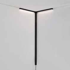 a light that is on the side of a wall in a room with white walls