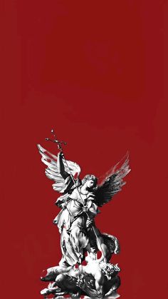 an angel statue is shown against a red background